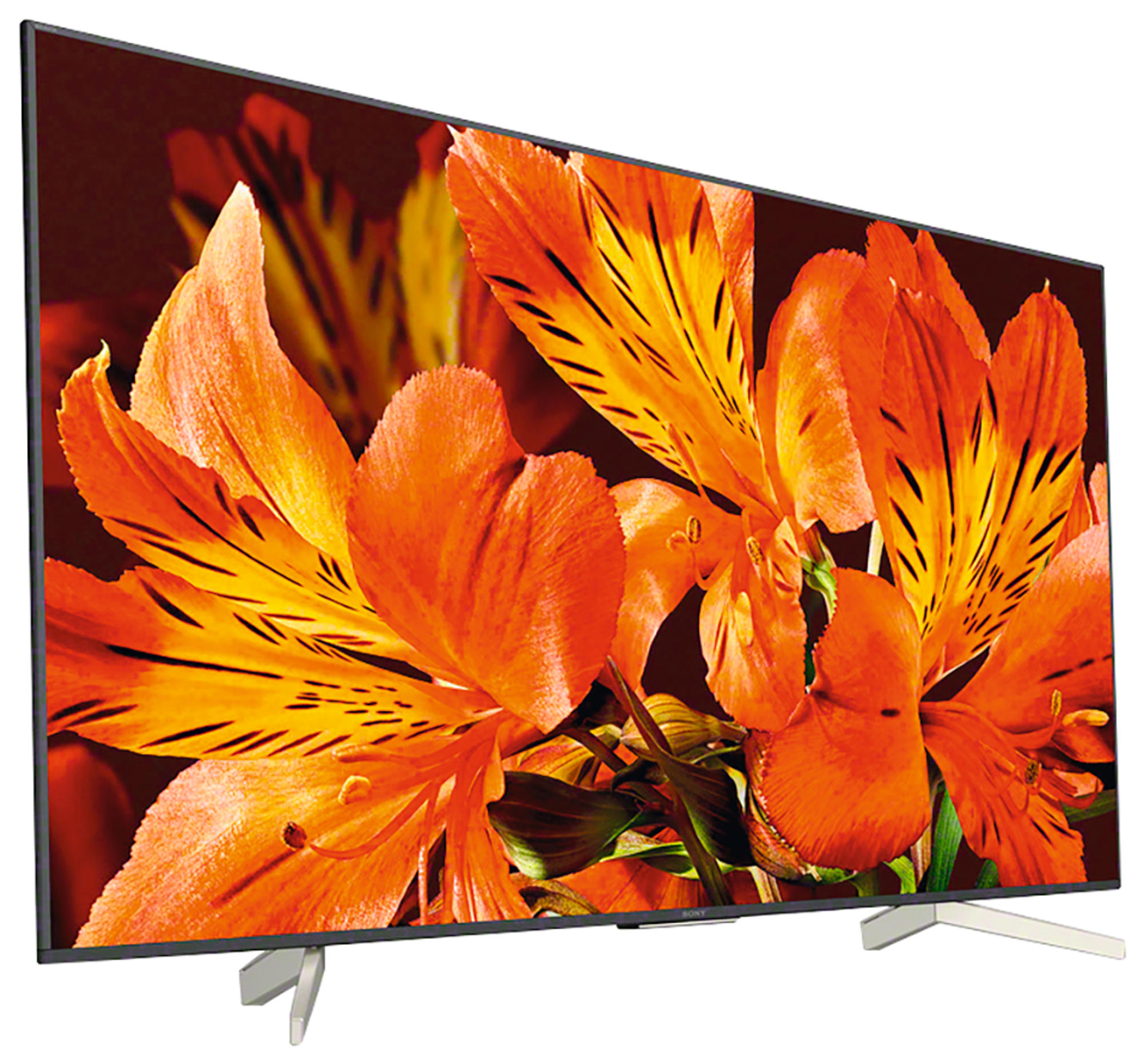 Un televisor de pantalla plana moderno muestra una vibrante imagen floral naranja. Soporte plateado, marco negro.