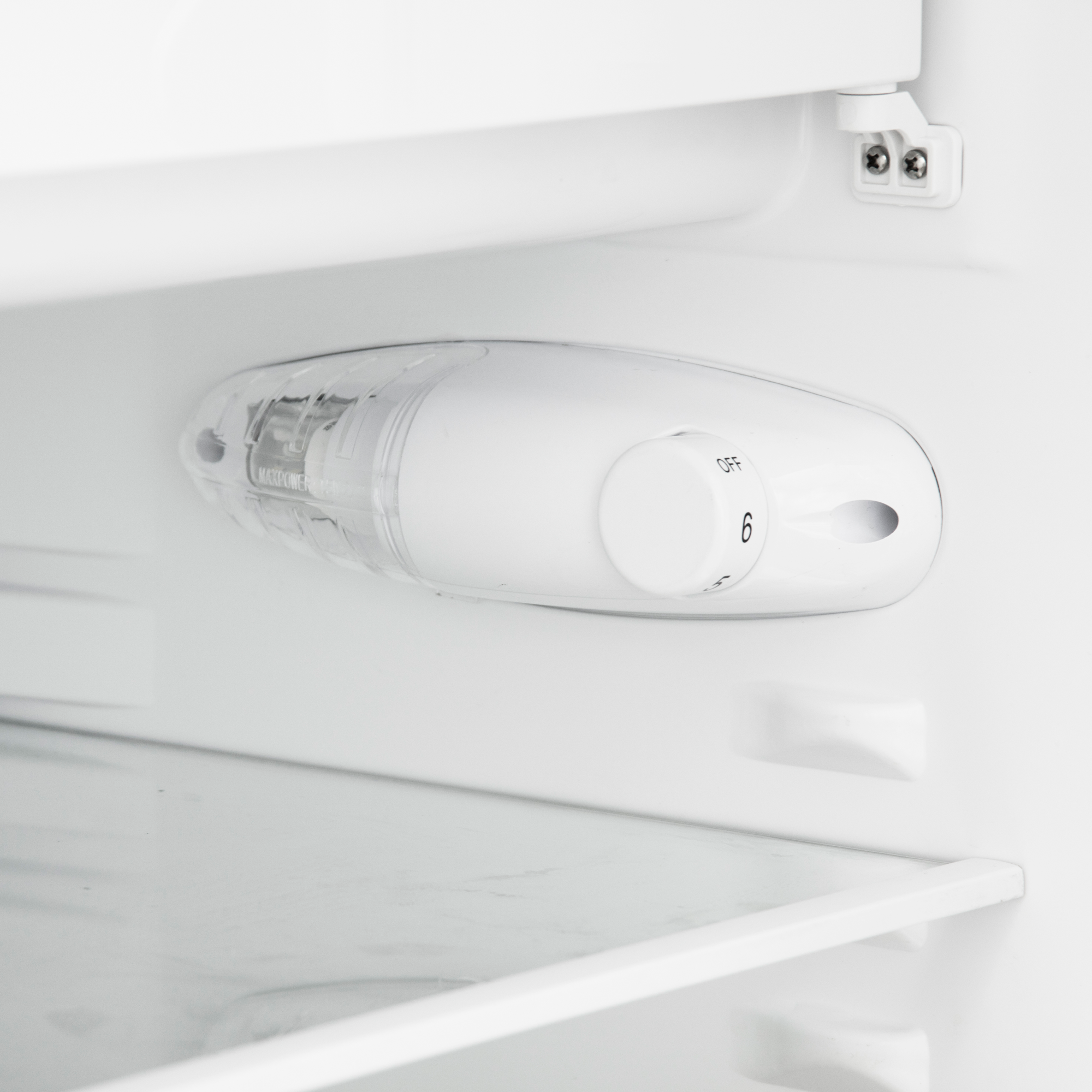 A white refrigerator thermostat with a dial numbered 1 to 6 and an OFF setting.