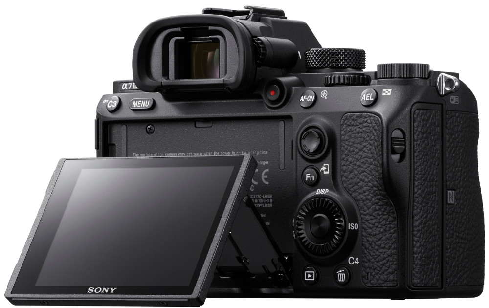 The back of a Sony camera with the LCD screen flipped out. The camera sits against a white background.