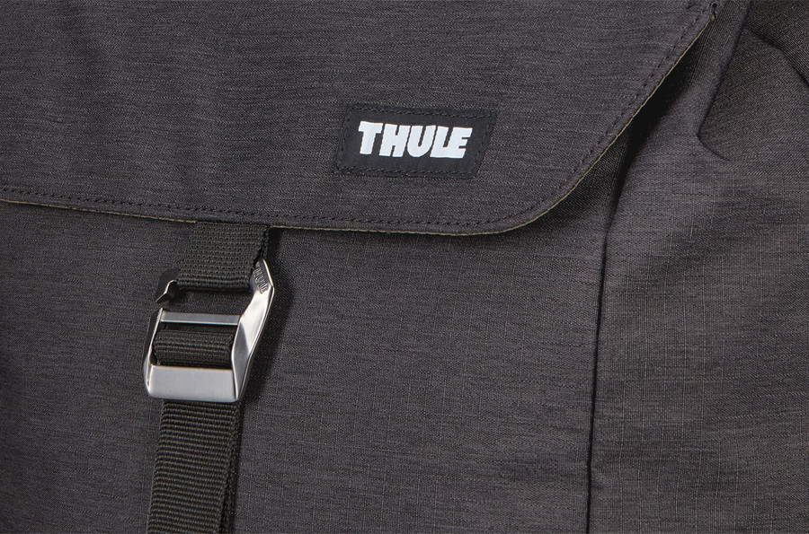 Black Thule backpack, with a white Thule logo on the top flap.