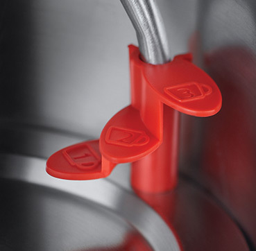 Close-up of kettle spout with red levers. Levers marked with cup symbols, indicating cup sizes.