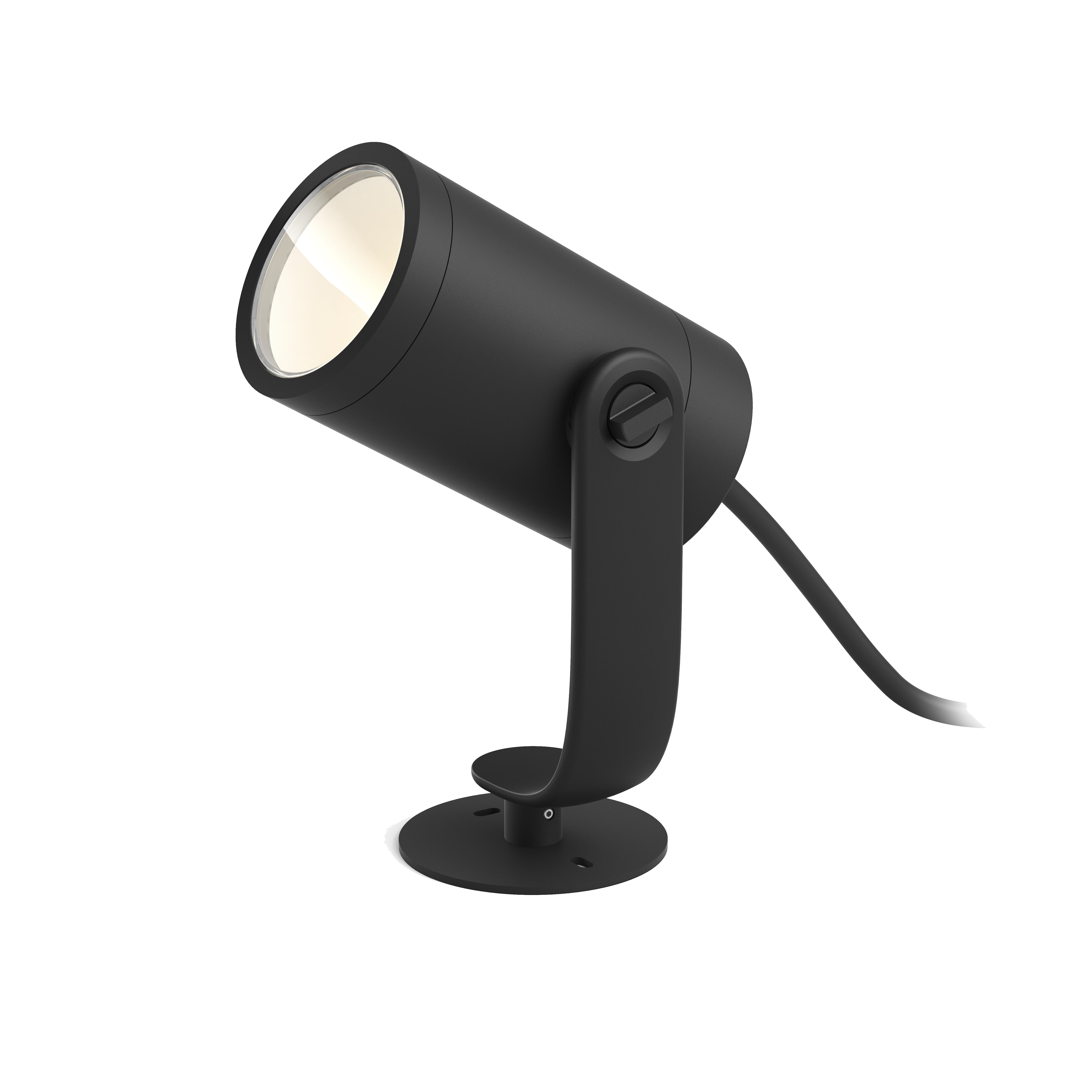 A black spotlight, angled, on a black base, with a light shining.