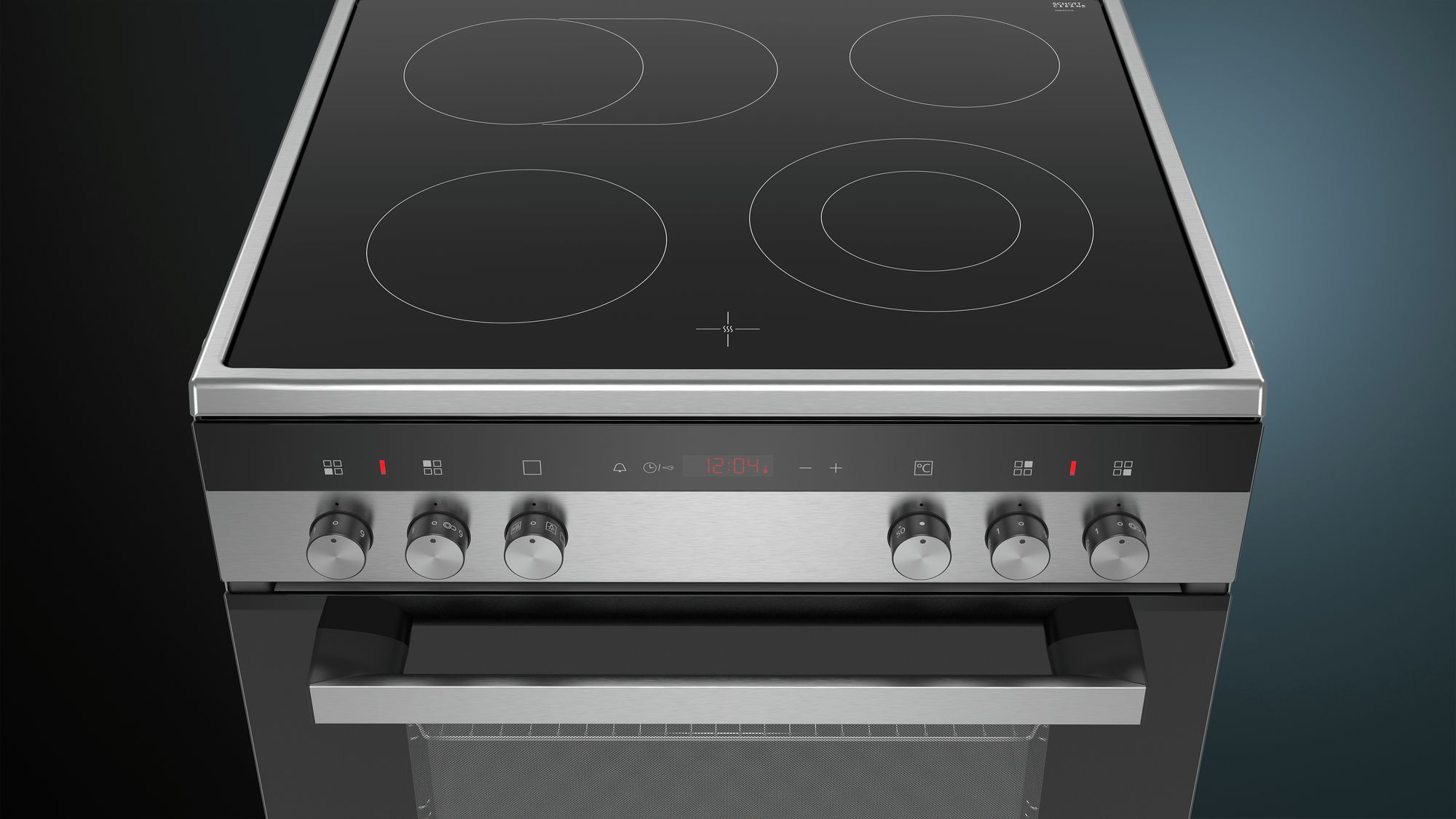 A stainless steel oven with four burners, a digital display, and control knobs.
