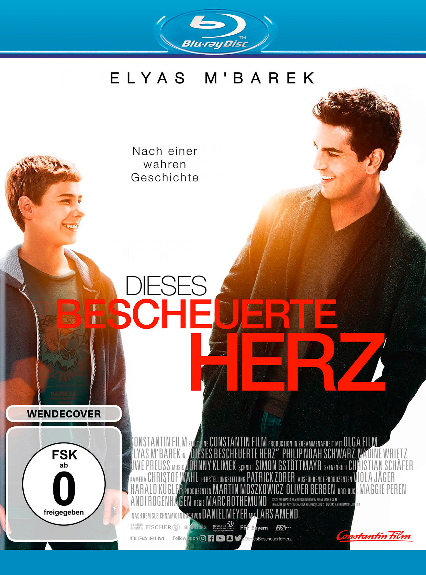 Filmcover mit zwei lächelnden Männern mit deutschem Text.