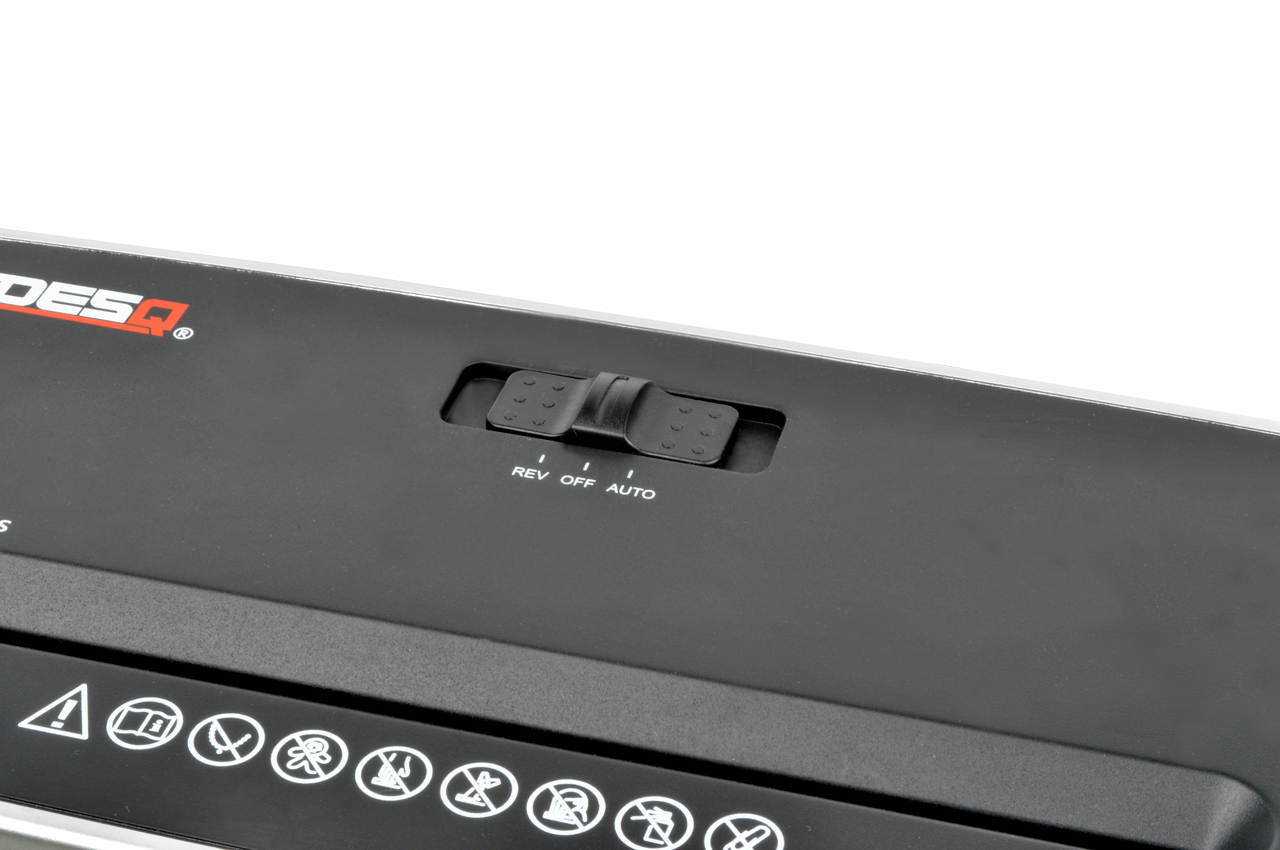 Black paper shredder control panel. Features reverse, off and auto settings.