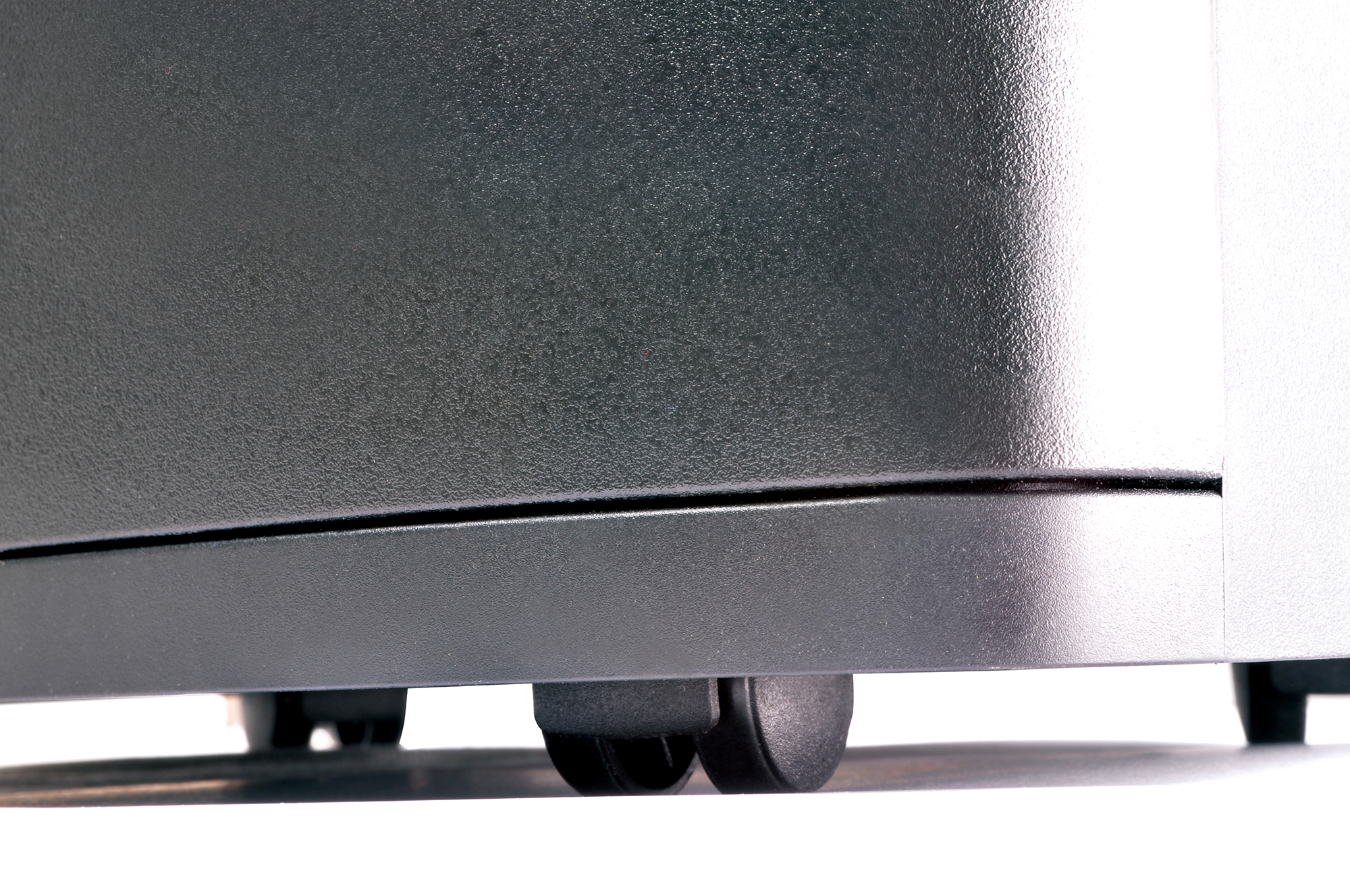 Close-up of a silver machine's bottom with wheels.
