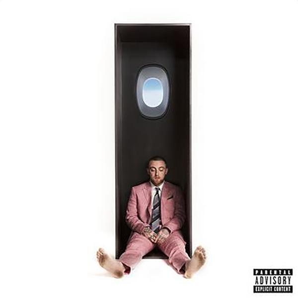 Albumcover mit einem Mann in rosa Anzug, der in einer schwarzen Box mit Fenster sitzt.