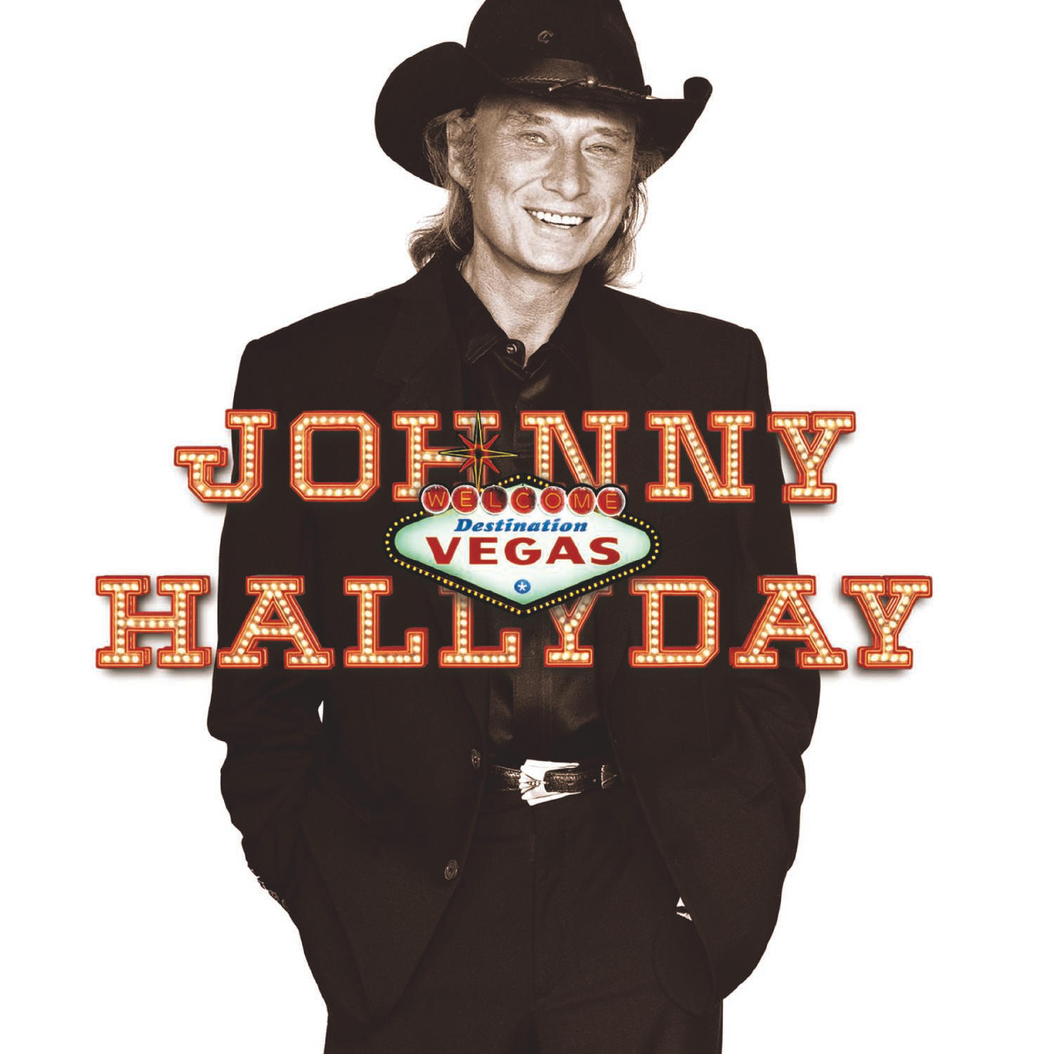Johnny Hallyday, en costume et chapeau noirs, fond blanc, avec texte.