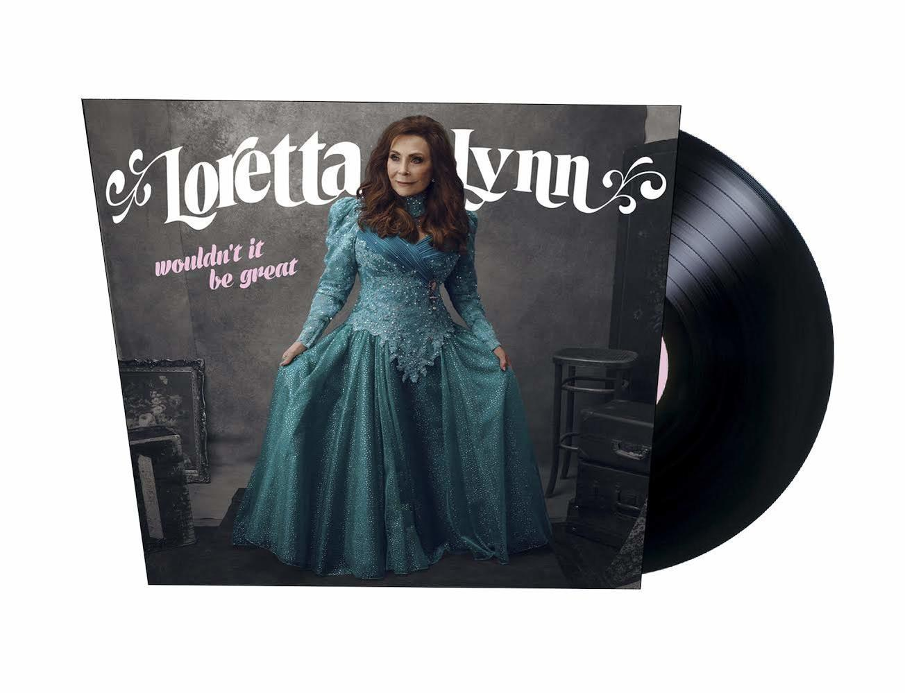 Albumcover von Loretta Lynn. Sie trägt ein tealfarbenes Kleid, rechts eine Schallplatte. Der Hintergrund ist grau mit Text.