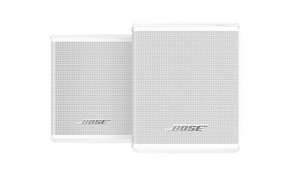 Two white Bose speakers. The speakers have a rectangular shape with many small holes.