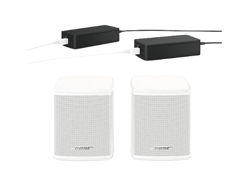 Two white Bose speakers and two black power adapters with white cables.