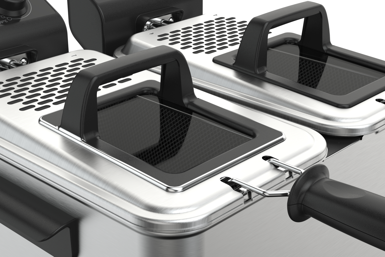 Close-up of stainless steel deep fryers with black handles, lids, and a frying basket handle in the foreground.