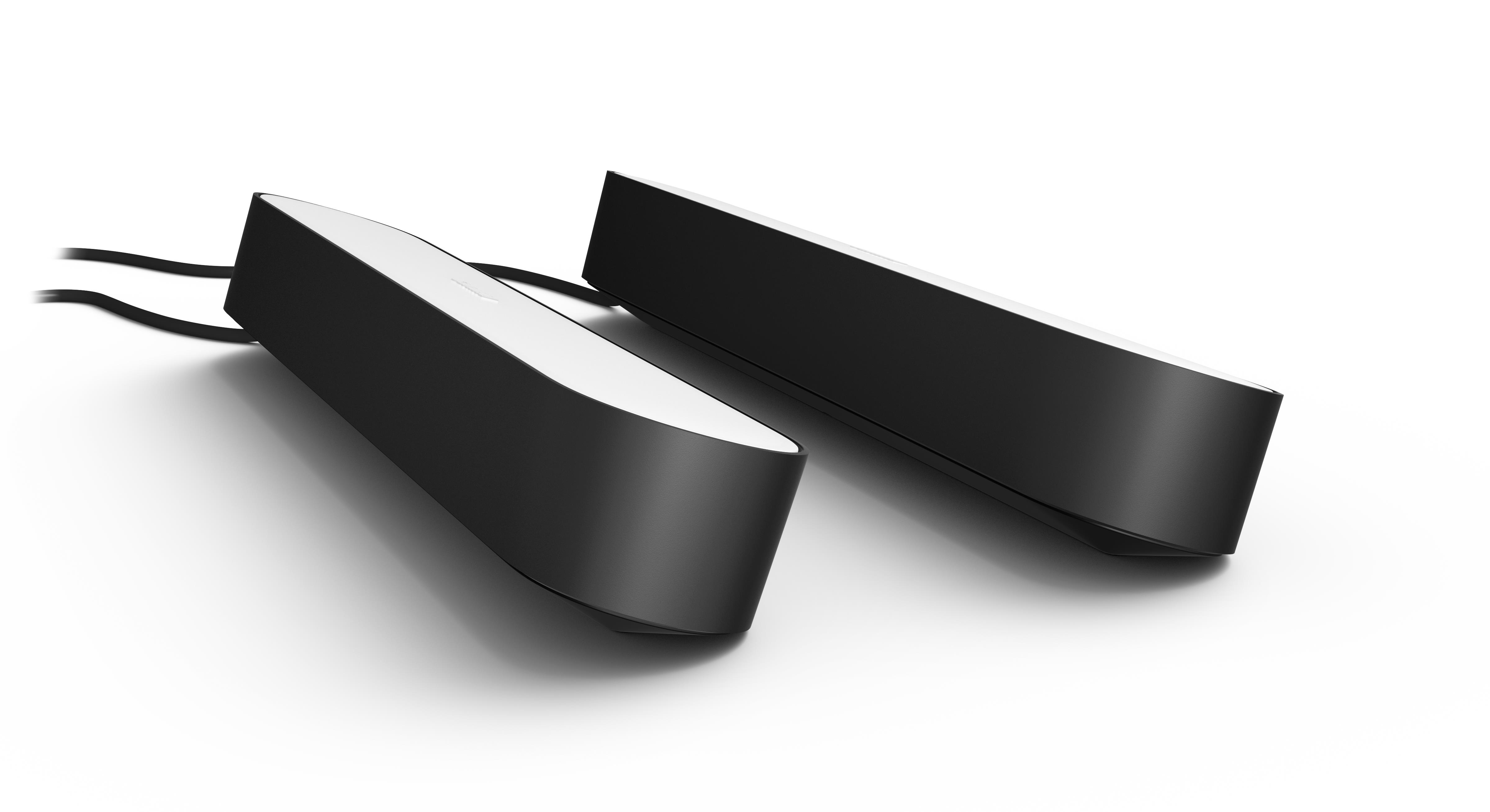 Two black Philips Hue light bars with white top surfaces, on white.