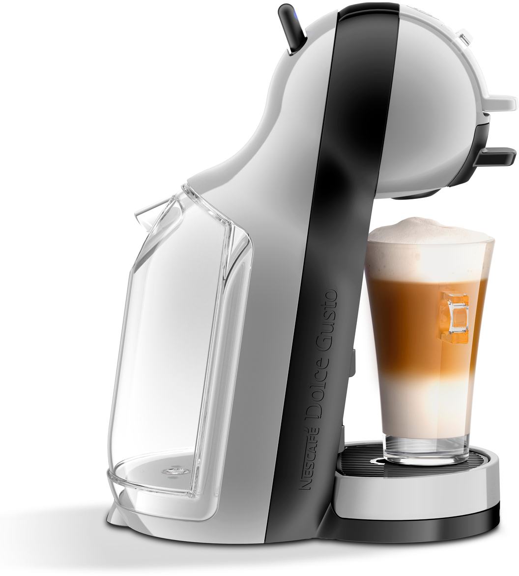 Machine à café blanche et grise, avec un verre de latte. Base noire, fond blanc. Dolce Gusto.
