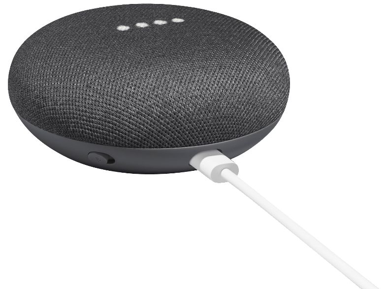 Un altavoz inteligente gris oscuro con un cable de carga blanco.