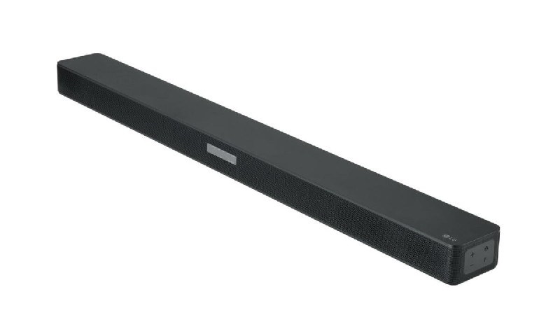 Barra de sonido LG negra sobre superficie blanca. El logo de LG es visible.