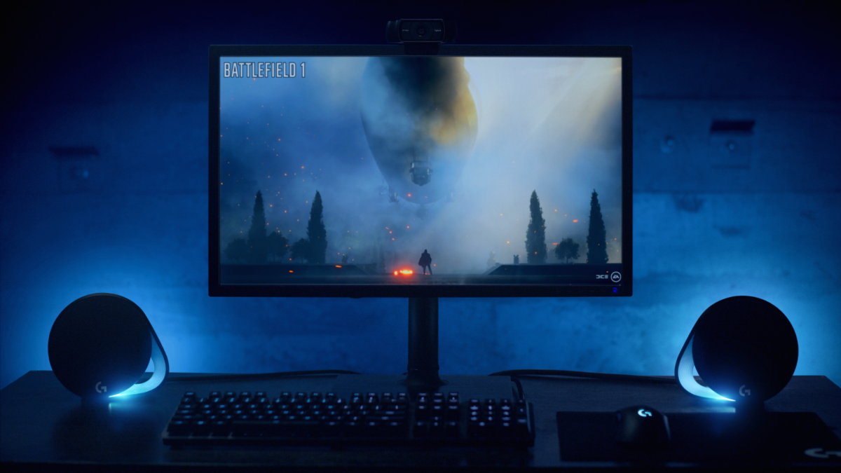 Una configuración de juego con un monitor que muestra 'Battlefield 1' y altavoces.
