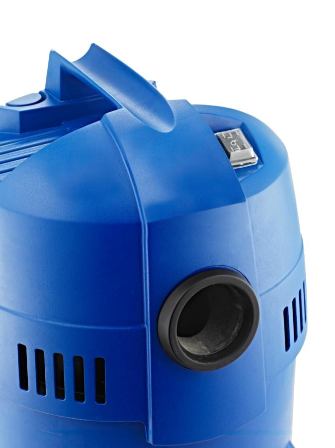 Primer plano de una parte azul de aspiradora con asa, puerto e interruptor. El fondo es blanco.