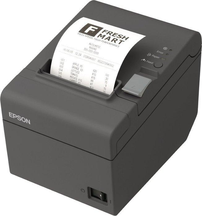 Una impresora térmica Epson imprimiendo un recibo de Fresh Mart con detalles del producto y un logotipo.