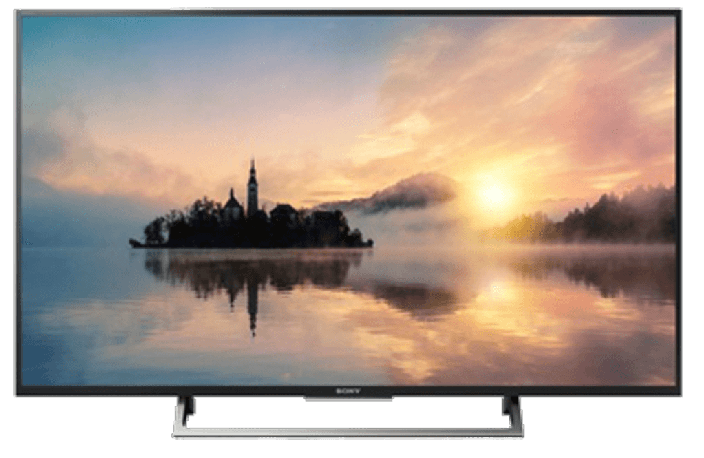Pantalla de TV negra grande mostrando una vista escénica de agua, árboles y atardecer.