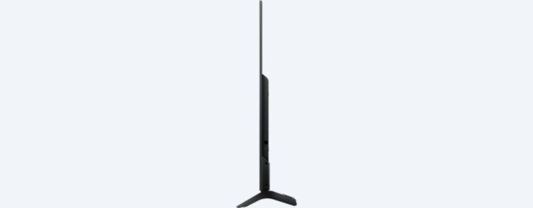 Vista lateral de un televisor negro con un soporte negro. La pantalla es delgada.