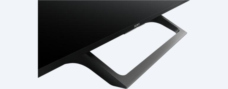 Una base de TV Sony negra. Es un diseño curvo y abierto con el logotipo de Sony visible.