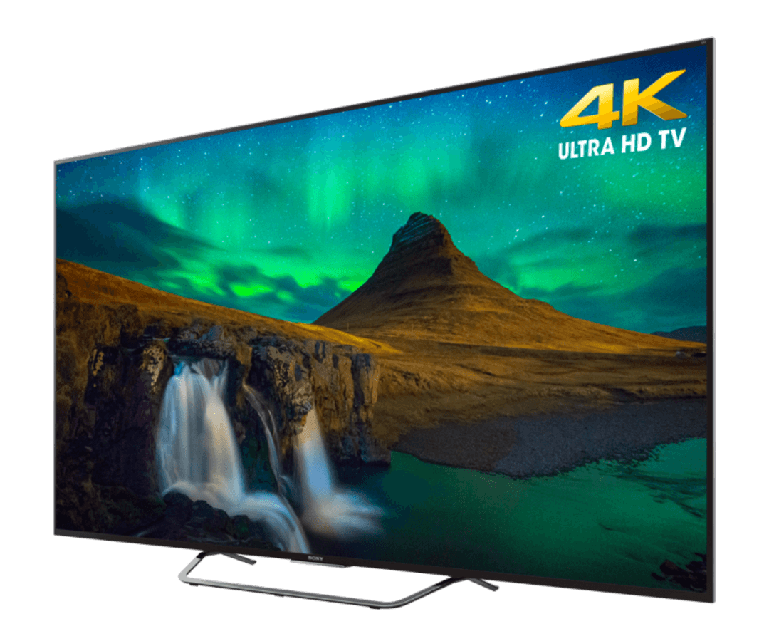 TV 4K Ultra HD mostrando un paisaje con cascadas y cielo estrellado. El televisor es negro.