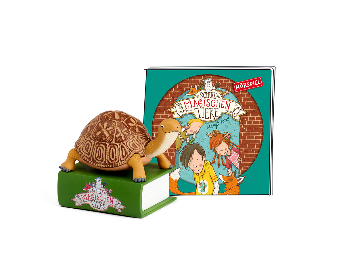 Schildkrötenspielzeug auf einem Buch und einem Buch mit dem Titel Die Schule...
