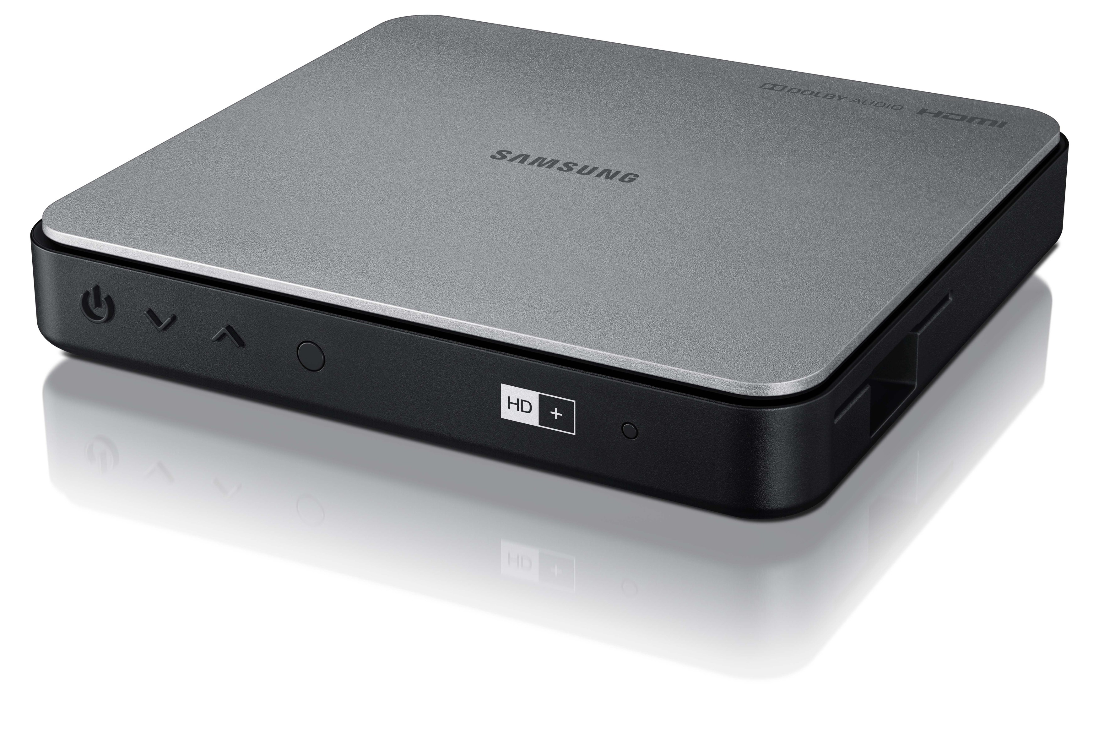 Eine Samsung Media Box, graue Oberseite, schwarze Basis, mit Ein/Aus, hoch, runter und HD+ Taste.