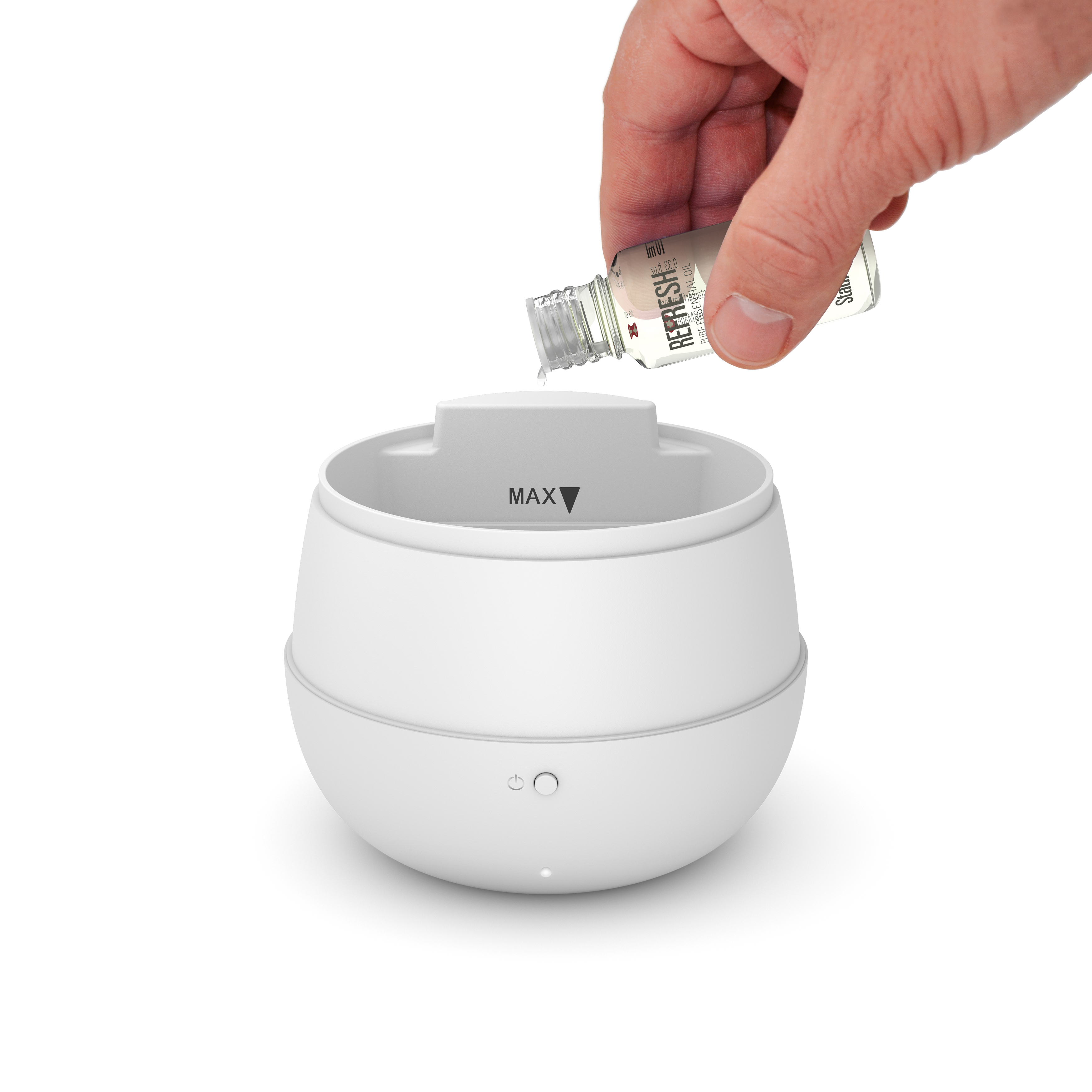 Eine Hand gießt ätherisches Öl in einen weißen Diffusor für ätherische Öle. Der Hintergrund ist weiß.