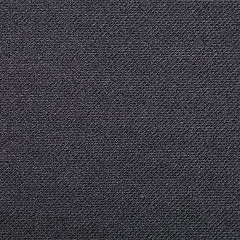 Primer plano de una superficie textil gris oscuro y texturizada.