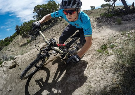 Ciclista de montaña bajando por un sendero de tierra.