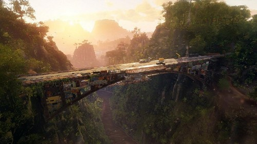 Puente en jungla, vegetación verde y fondo montañoso.