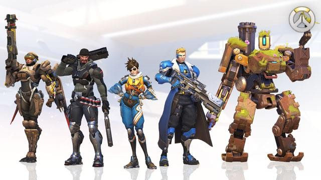 Personajes de Overwatch en fila. Seis personajes con diferentes atuendos, con armas, sobre una superficie blanca.