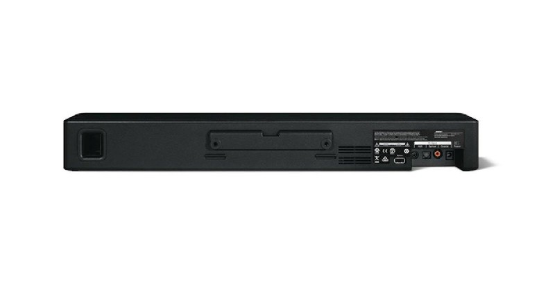 Una barra de sonido negra con un altavoz y puertos en la parte trasera.