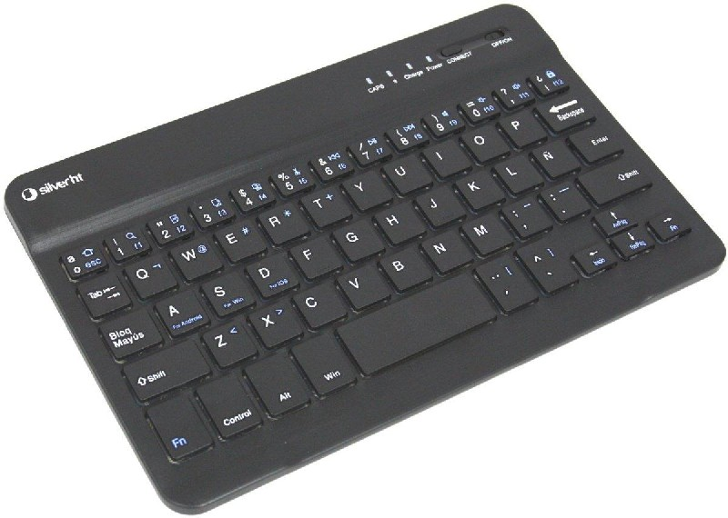 Un teclado negro y rectangular con teclas blancas. El teclado está sobre una superficie blanca.