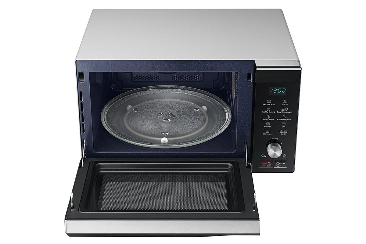 Un horno microondas plateado con la puerta abierta, mostrando el interior, fondo blanco.