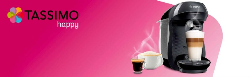 Cafetera Tassimo Happy con una taza de café y un chupito de espresso. Fondo rosa.