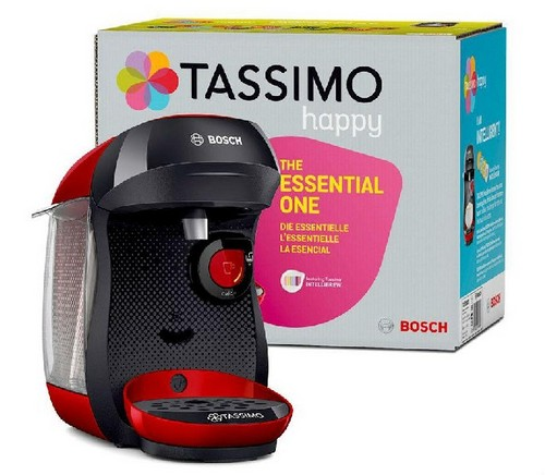 Una cafetera Tassimo negra y roja junto a una caja. La caja tiene texto y diseños coloridos.