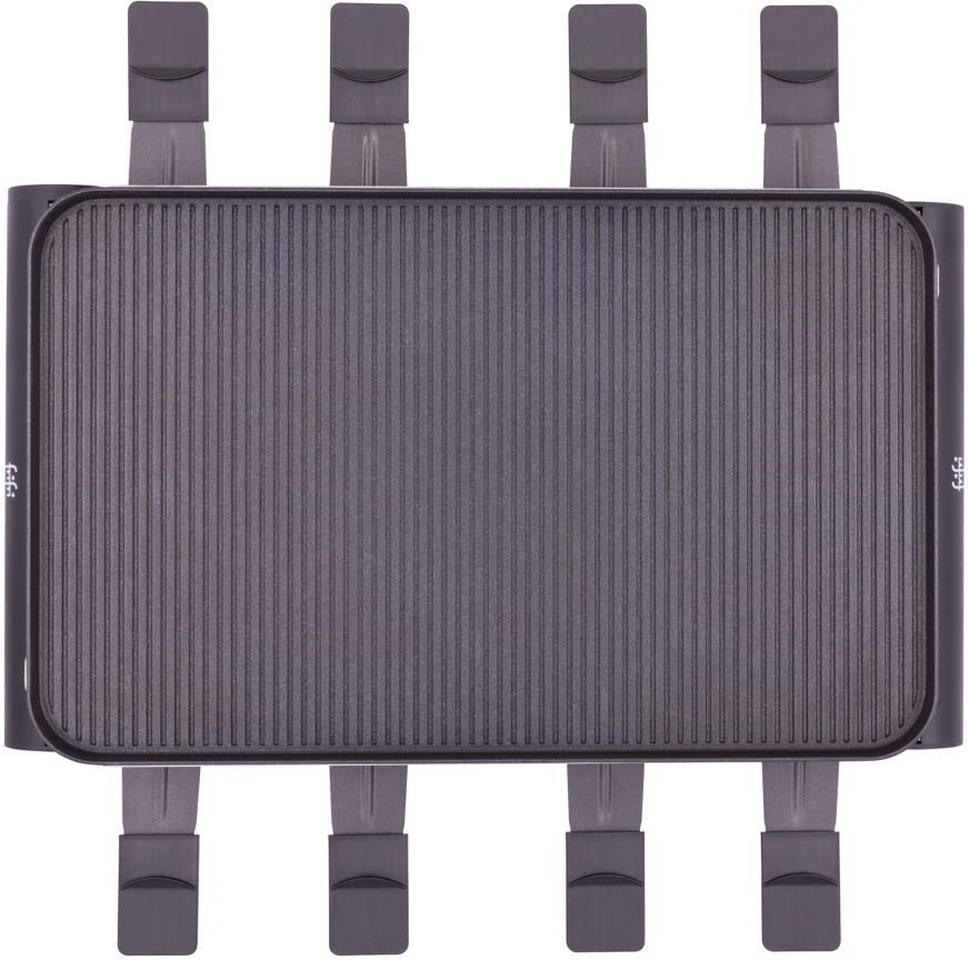 A dark gray raclette grill with eight individual feet and a ridged cooking surface.
