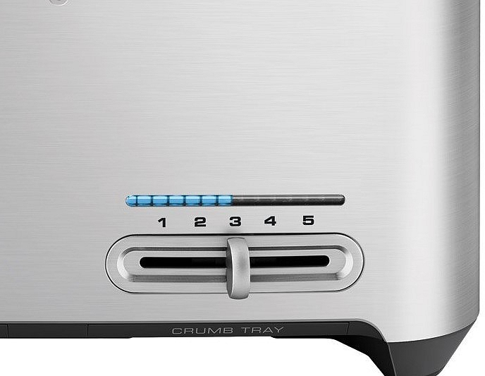 Detail eines silbernen Toasters, mit blauem Licht und einem Krümelbehälter.