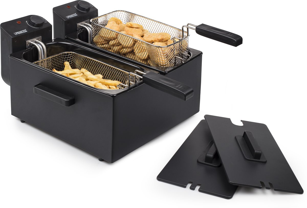 Black deep fryer with two baskets holding fries and nuggets. Two lids are in the foreground.