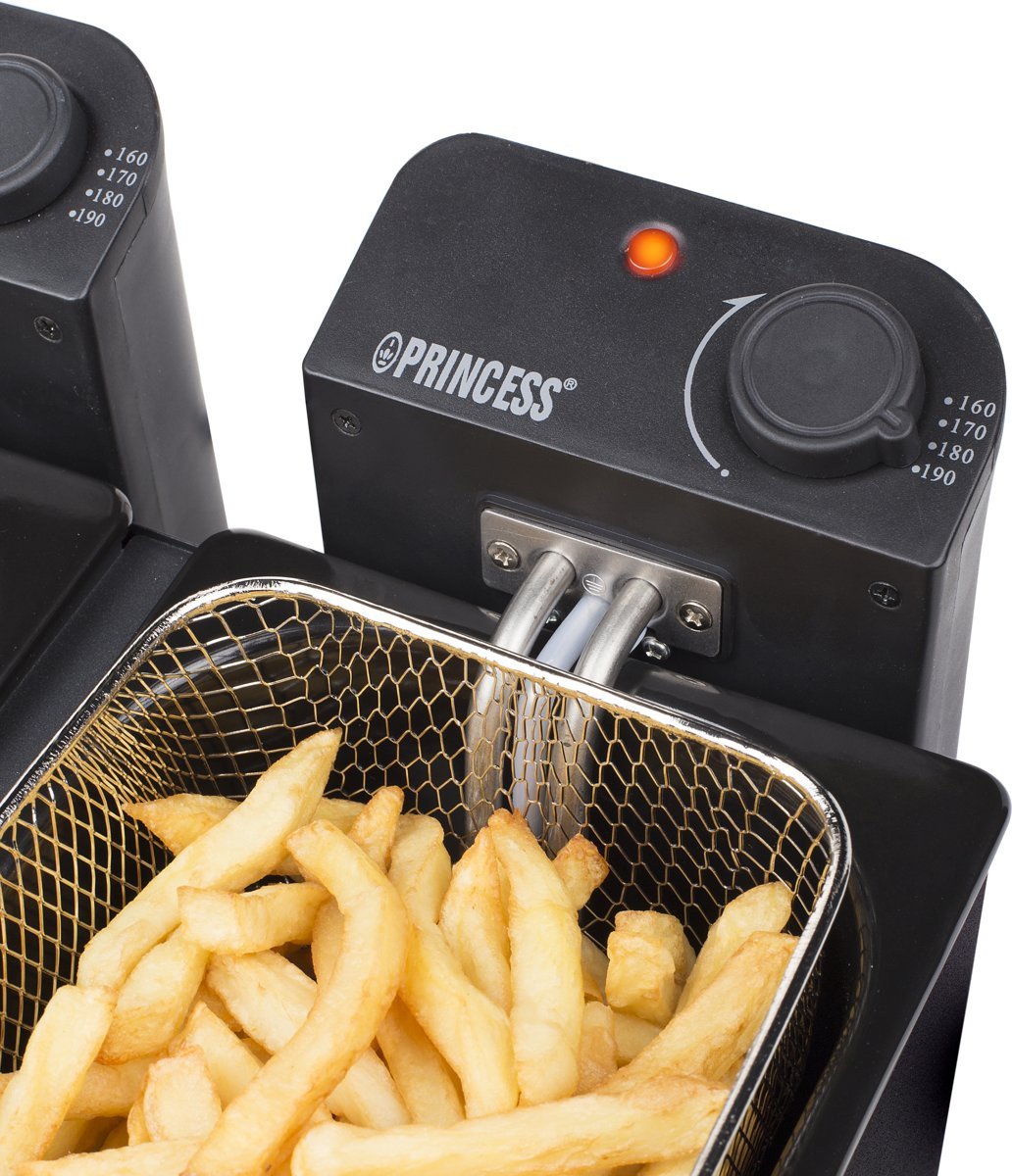 Close-up of a Princess deep fryer with french fries. Black and silver.
