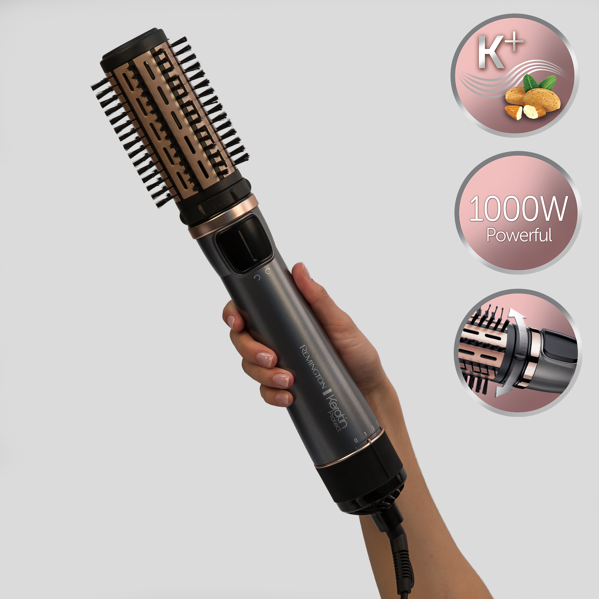 Hand holding a Remington Keratin Protect rotating air styler.