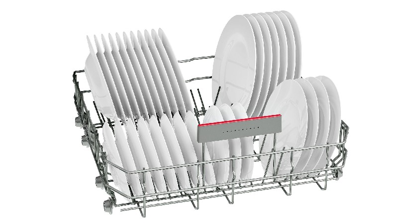 Una rejilla de lavavajillas sostiene platos blancos y limpios. La rejilla es de metal y los platos están dispuestos en ranuras para secar. Se ve una barra roja y gris.