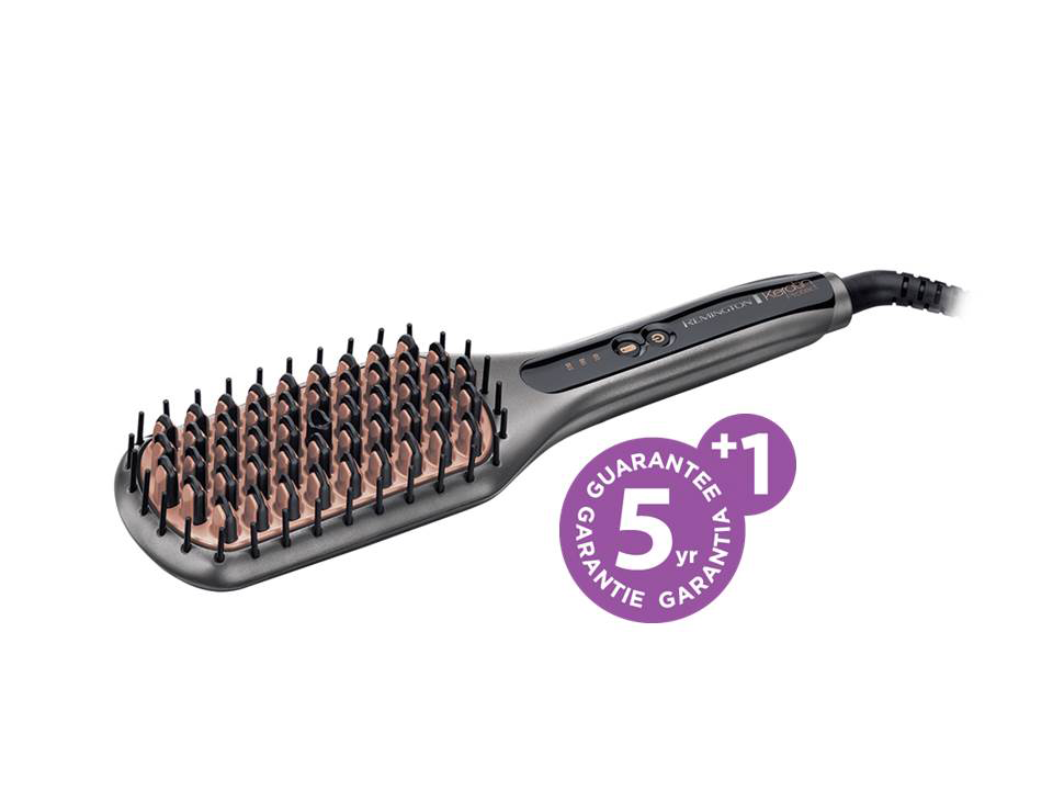 Een grijze Remington Keratin haarstijltangborstel met roze borstelharen en een garantie sticker.