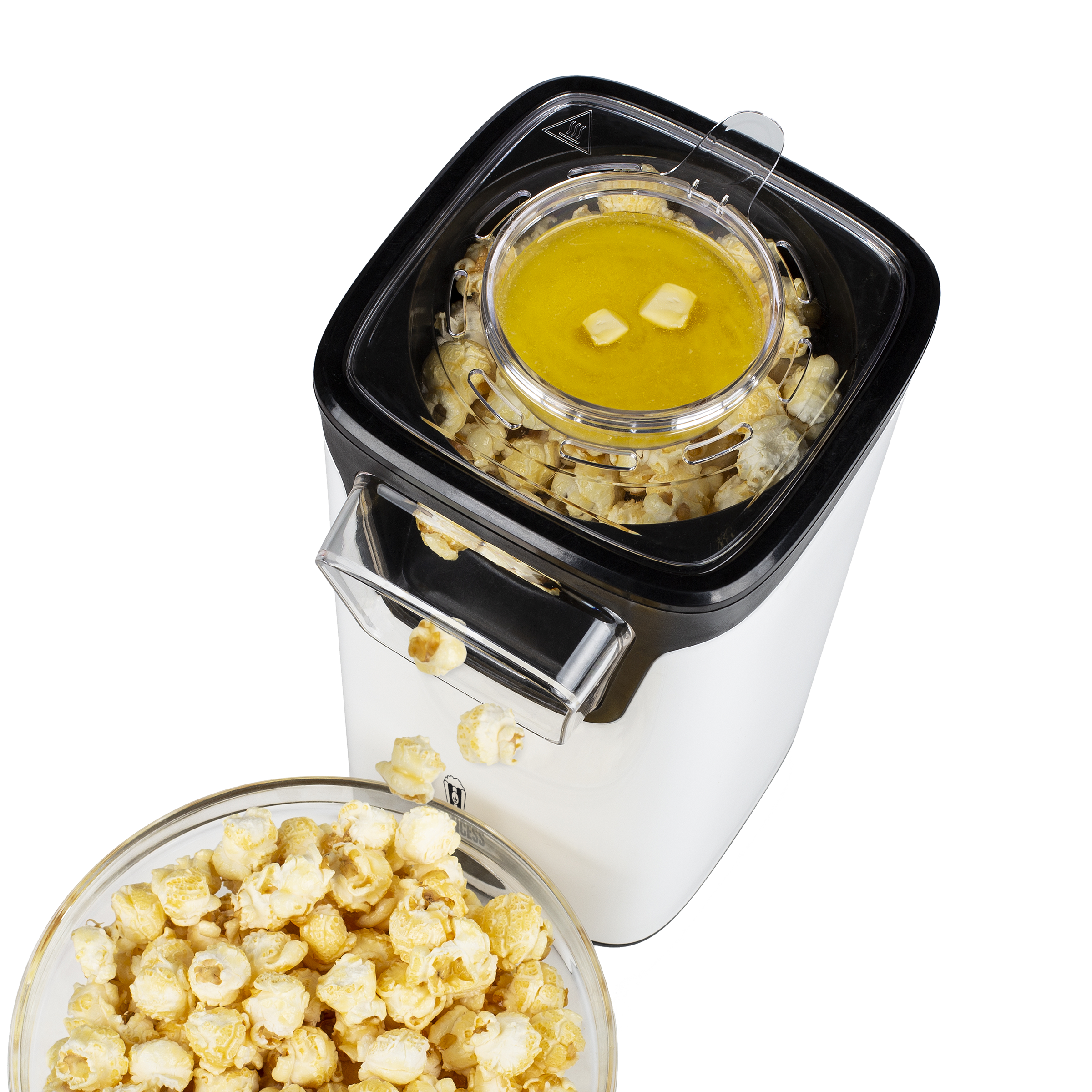 Een witte en zwarte popcornmaker. Het heeft een kom met gesmolten boter en een kom met gepofte maïs.