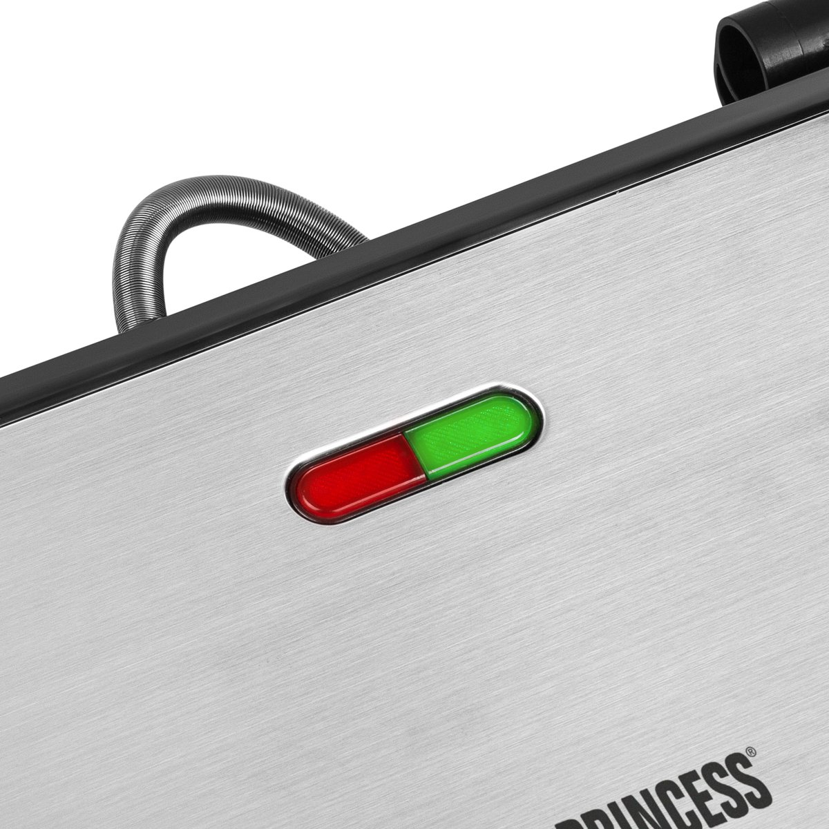 Close up of a silver appliance with a red/green indicator light.