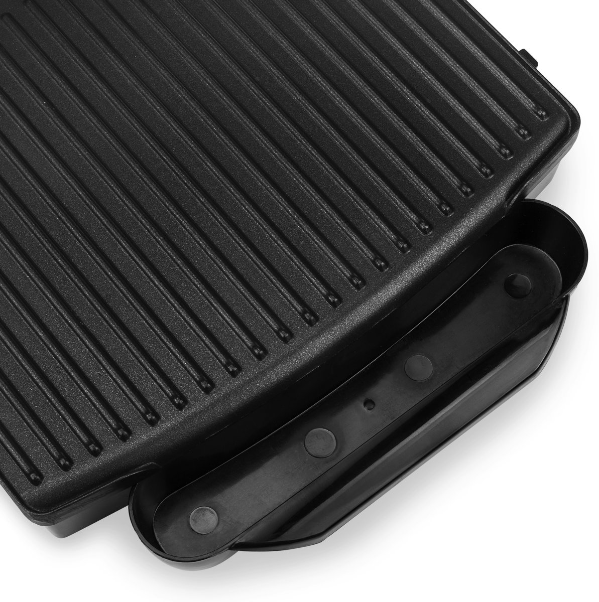 A close-up of a black grill, showing the ribbed surface and a handle, white background.