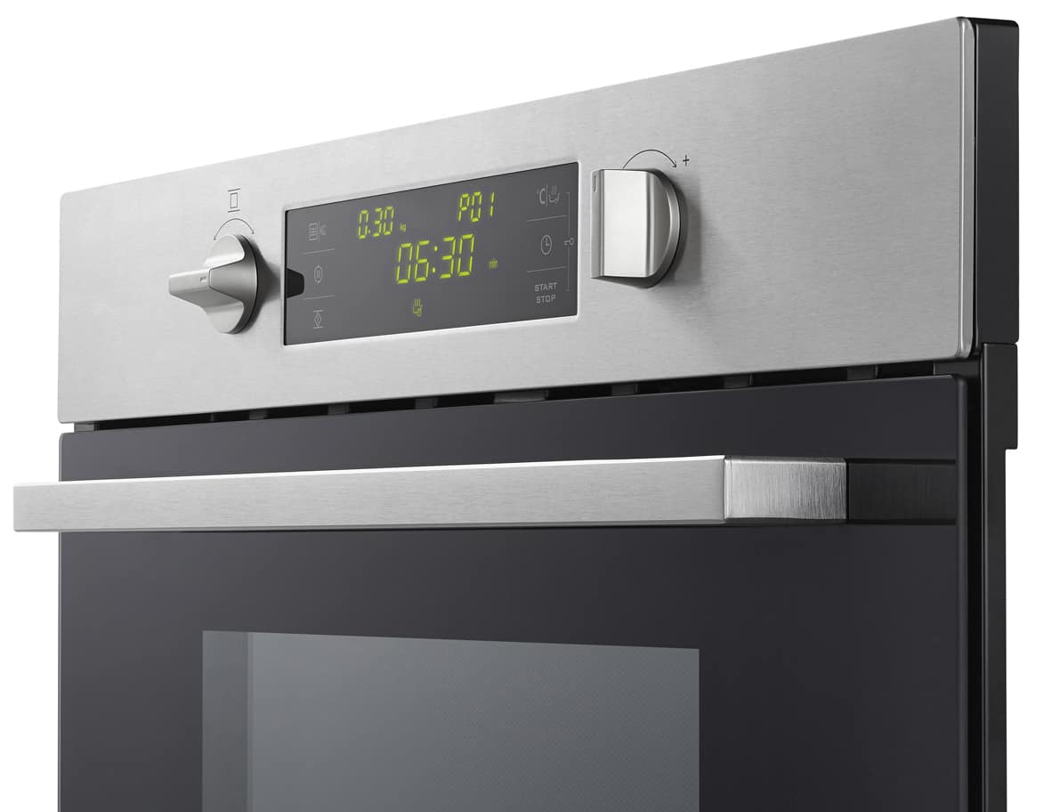 Oven control panel with display and knobs. Stainless steel surface. The background is white.